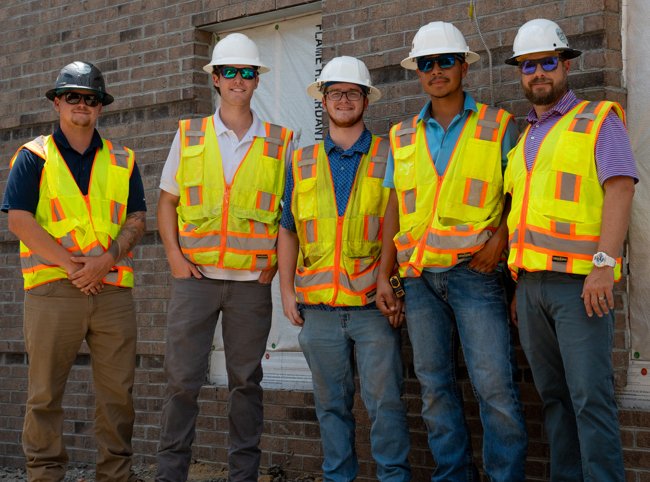 Mason working with an apprentice on a job site